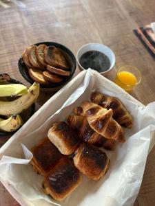 a tray of pastries and bananas on a table at Chambre d'hôtes "Sur la route des Terrils" in Vendin-le-Vieil