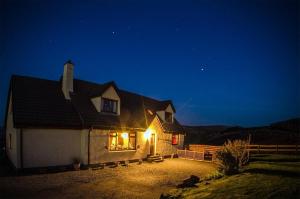 a house at night with lights on the side of it at The Thistle Guesthouse in Portree