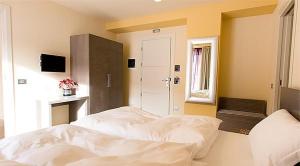 福爾加里亞的住宿－庫貝酒店，窗户客房内的一张大白色床