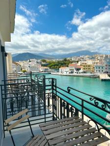 a balcony with benches and a view of the water at Casa Porto Boutique Hotel - Adults only in Agios Nikolaos