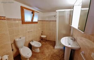a bathroom with a toilet and a sink at Villaggio Heliopolis in Manerba del Garda +58 photos