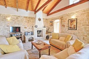 a living room with two couches and a fireplace at Villa Katerini in Gaios