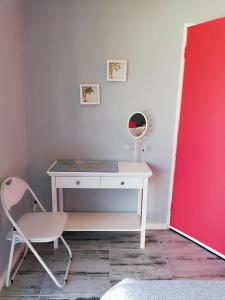 a desk in a room with a chair and a mirror at Nagua bay in Gordonʼs Bay