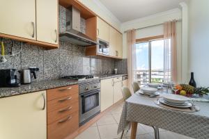 A kitchen or kitchenette at Ocean view Apartment with panoramic Terrace, 2 Swimming pools & Tennis court