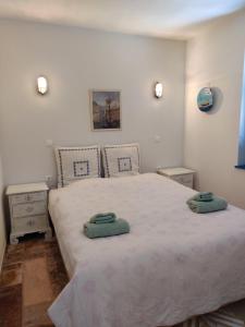 a bedroom with a bed with two towels on it at Marilia house in Hydra