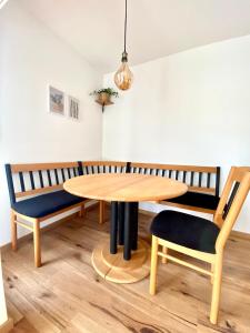 a dining room with a table and two chairs at Best Butler Family & Friends Fun Flat Netflix in Füssen