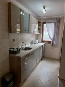 a small kitchen with a sink and a window at LERA APARTMENT in Burgas