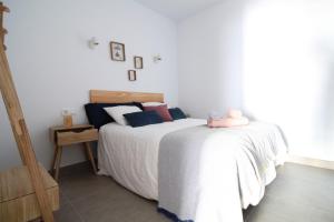 a bedroom with a bed with a stuffed animal on it at CASA MAR GINES , COMODIDAD Y CERCANIA A TU MANO. in La Santa