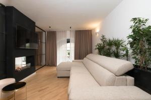 a living room with a couch and a tv at Brera Premium Apartment near Duomo Wifi in Milan
