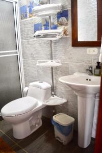 a bathroom with a toilet and a sink at El Portal De Don Luis in Guadalupe