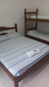 a pair of bunk beds in a room at Ombak Guest House in Ubatuba