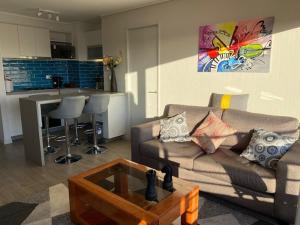 a living room with a couch and a table at Departamento Amoblado con excelente ubicación in Concepción