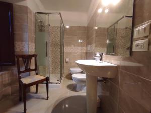 W łazience znajduje się umywalka, toaleta i prysznic. w obiekcie All'Archetto del Terz'Ordine w Asyżu