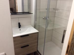 a bathroom with a sink and a shower at Hotel Restaurant de la Poste in Aullène