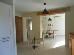 uma cozinha e sala de jantar com mesa e cadeiras em Le Mas des Meras - Gite Côté mas em Lurs