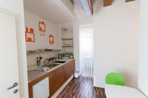 a kitchen with a white counter top and white cabinets at CUBE central rooms for 2 in Ljubljana