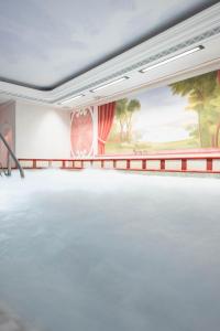 a large room with a large painting on the wall at Hotel Colbricon Beauty & Relax in San Martino di Castrozza