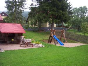 un parque infantil con un tobogán, una mesa y un banco en Černý důl 18, en Černý Důl