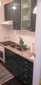 a kitchen with a sink and a microwave at Apartman Bruna in Zagreb