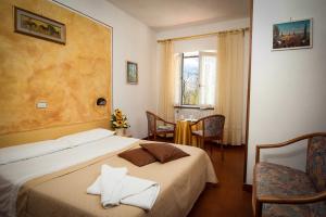 Postel nebo postele na pokoji v ubytování Albergo Ristorante il Fungo