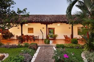 a house with a patio and a table and chairs at Hotel Boutique Adela in Granada