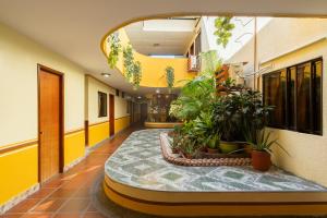 an empty hallway with plants in a building at Hotel Costa mar in Barranquilla