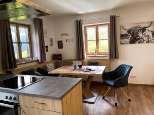 a kitchen with a table and a dining room at Haus Freynend in Anger