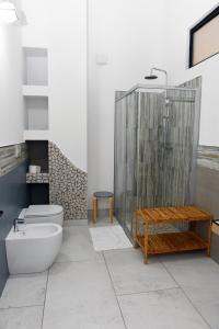 a bathroom with a shower and a toilet and a sink at La Pineta del Borgo in Ravenna