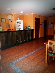 
a kitchen with a wooden floor and wooden cabinets at Los Acebos Cangas in Cangas de Onís
