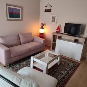 a living room with a couch and a tv at casa mariuccia in San Nicola La Strada