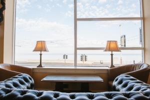 a waiting room with two lamps in front of a window at Park House Hotel in Blackpool