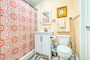 a bathroom with a toilet and a shower curtain at Stunning 2-Building Rental - Walk to Marina! in Celina +32 photos