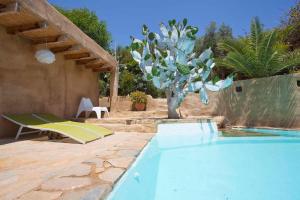 a swimming pool with a tree in a yard at Casa La Chumbera Blanca in Mojácar