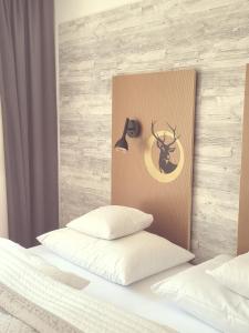 a bedroom with a headboard with a deer on it at Hotel Scholz in Aalen