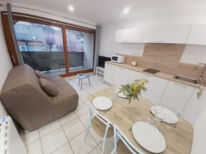 a living room with a couch and a table at Appartement T2 avec balcon à Argelès Gazost in Argelès-Gazost