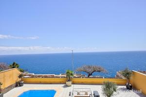 vistas al océano desde el balcón de un edificio en Villa Galasol with heated pool, en Radazul