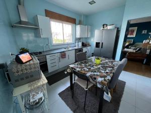 a kitchen with a table and a kitchen with a refrigerator at Paradise in Camarate