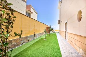A garden outside Villa Galasol with heated pool