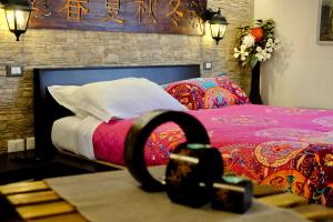 a bedroom with a bed with a red blanket at Peperosa in collina B&B in Pescara