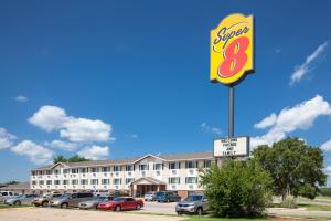 a sign for a share eight motel with a parking lot at Super 8 by Wyndham Manhattan KS in Manhattan