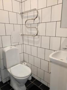 a white bathroom with a toilet and a sink at Apartment Südalinnas in Haapsalu