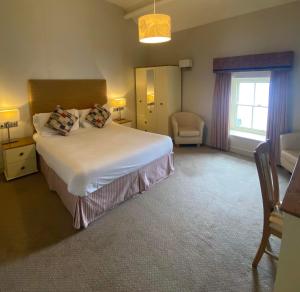 מיטה או מיטות בחדר ב-Garddfon Inn