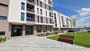 a building with a bench in front of it at West Homes 34 in Oradea