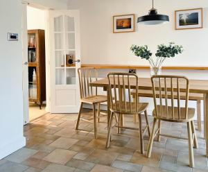 a dining room with a table and chairs at Bright & Cosy - Jacuzzi - Log Burner - King Beds in Tangmere