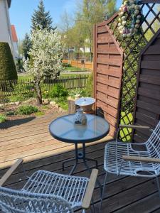 a table and two chairs on a wooden deck at Simply Good Appartment in Borna