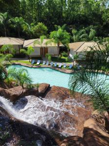 an image of a swimming pool with a waterfall at Hotel Serra do Gandarela in Rio Acima