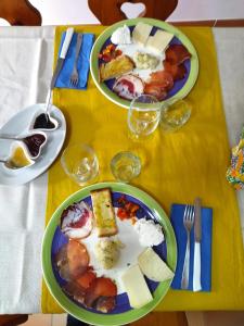 Ielsi的住宿－Agriturismo Masseria Testa Ciruglio，一张黄色桌子,上面有两盘食物