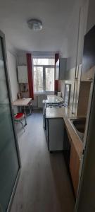 a kitchen with a sink and a table in it at Apartament La Denis in Bîrlad