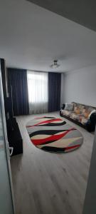 a living room with a large rug on the floor at Apartament La Denis in Bîrlad