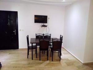 卡薩布蘭卡的住宿－family home，餐桌、椅子和墙上的电视
